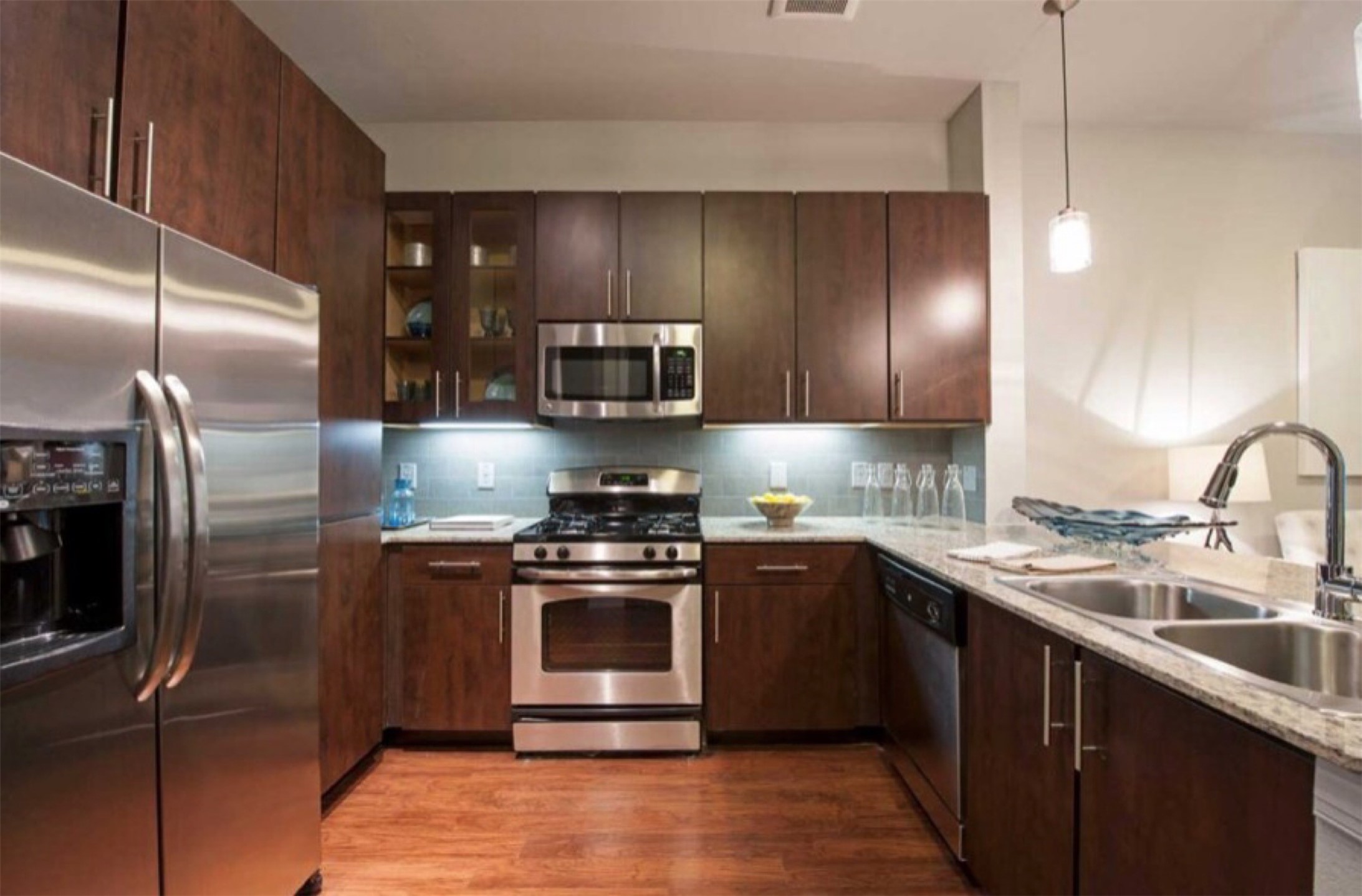 2525 McCue Road, Unit 153 Houston, TX 77056 - Photo 25 of 32 a kitchen with stainless steel appliances granite countertop a sink a stove a refrigerator and cabinets