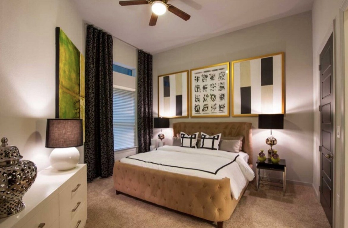 2525 McCue Road, Unit 112 Houston, TX 77056 - Photo 29 of 32 a spacious bedroom with a bed and a chandelier