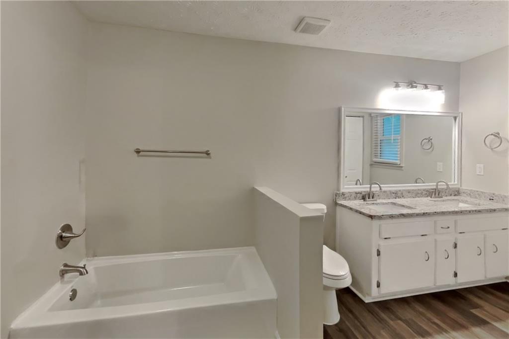 3117 Calumet Circle Northwest Kennesaw, GA 30152 - Photo 11 of 21 a bathroom with a granite countertop sink a mirror and a bathtub