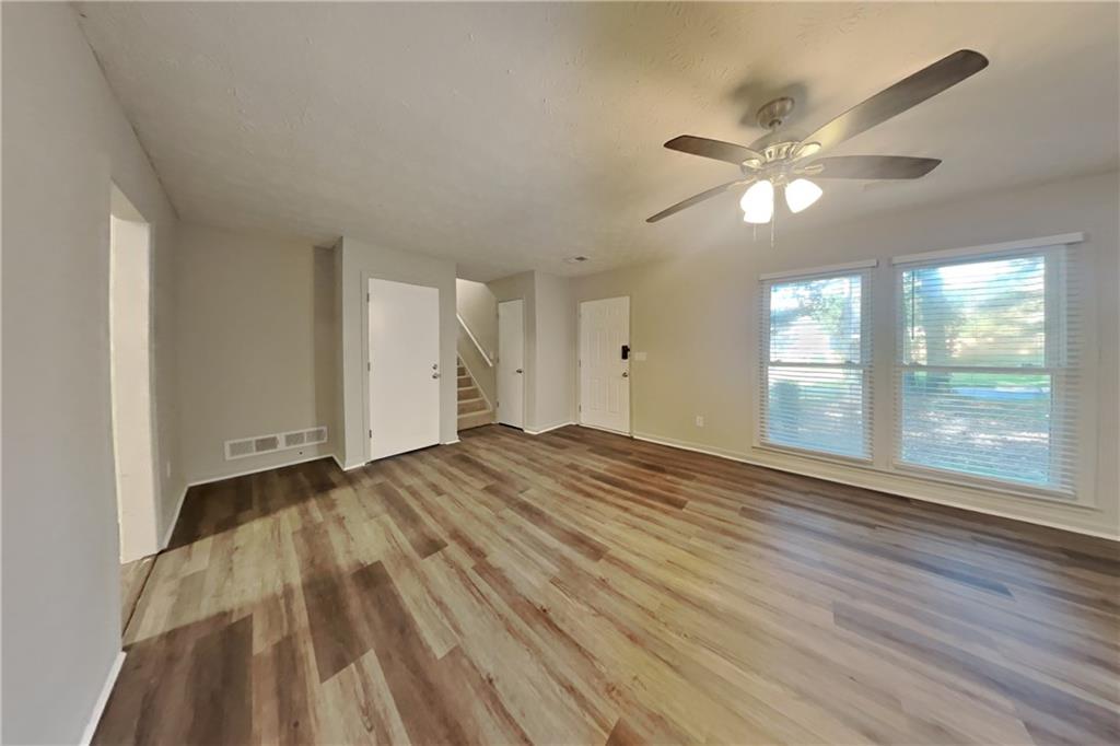 3117 Calumet Circle Northwest Kennesaw, GA 30152 - Photo 2 of 21 a view of empty room with wooden floor and fan