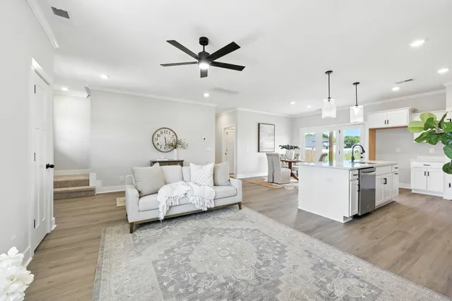a living room with furniture and kitchen view
