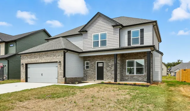 a front view of a house with a yard and garage