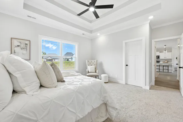 a bedroom with a bed and glass walk in closet