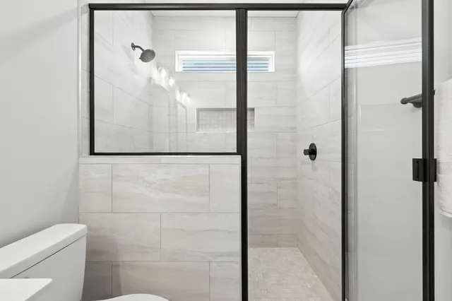a bathroom with a shower and toilet