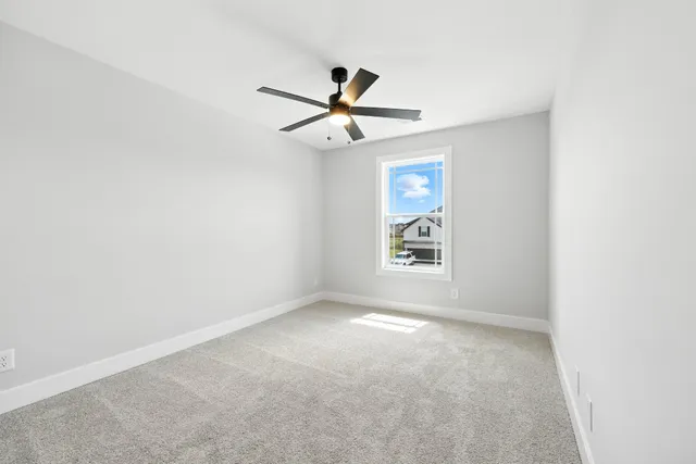 an empty room with ceiling fan