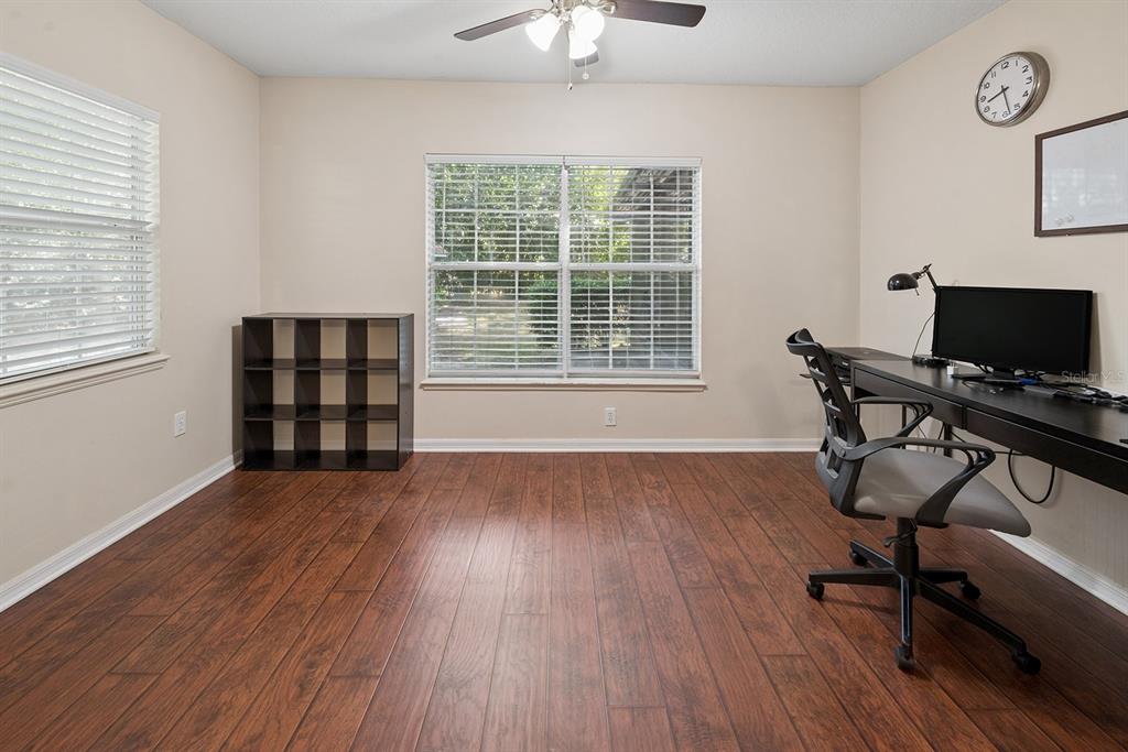 6924 Southwest 80th Drive Gainesville, FL 32608 - Photo 11 of 65 a view of a workspace with wooden floor and a window