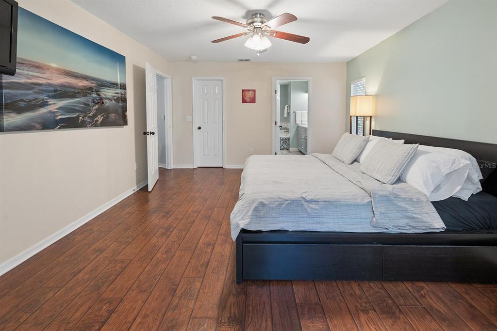 6924 Southwest 80th Drive Gainesville, FL 32608 - Photo 13 of 65 a bedroom with a bed and wooden floor