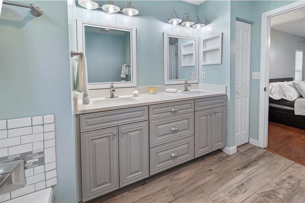 6924 Southwest 80th Drive Gainesville, FL 32608 - Photo 15 of 65 a spacious bathroom with a double vanity sink and a mirror
