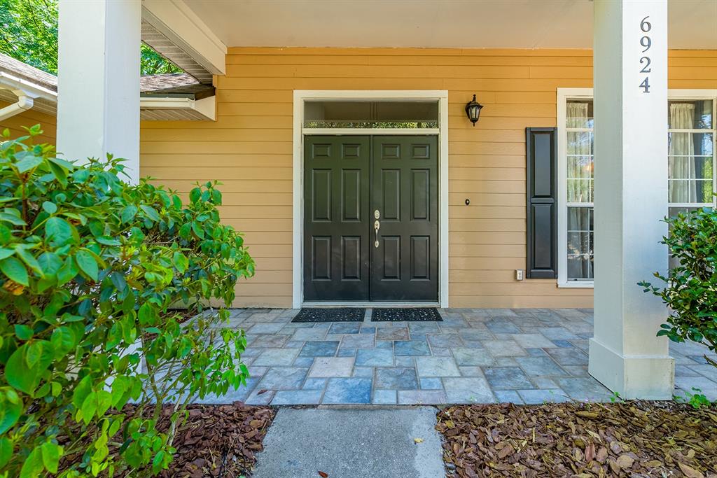 6924 Southwest 80th Drive Gainesville, FL 32608 - Photo 2 of 65 a view of yellow house with a large windows
