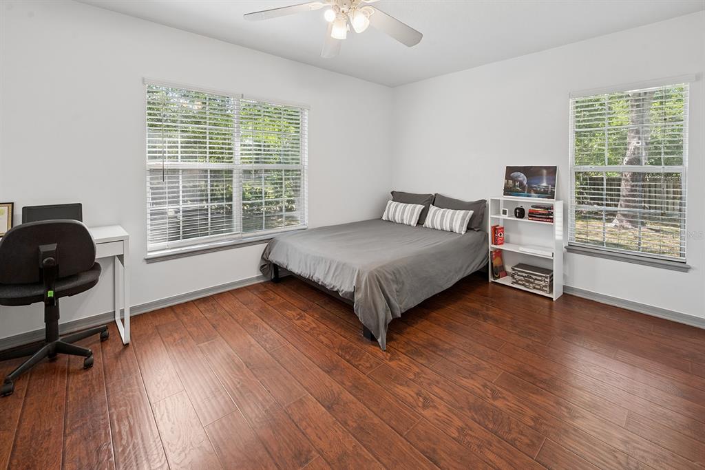 6924 Southwest 80th Drive Gainesville, FL 32608 - Photo 36 of 65 a bedroom with a bed and a chair