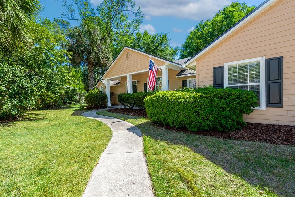 6924 Southwest 80th Drive Gainesville, FL 32608 - Photo 64 of 65 a view of a house with a yard and potted plants