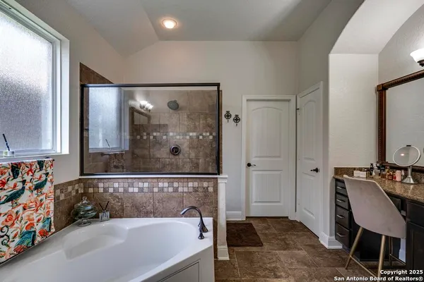 a bathroom with a bathtub and a shower