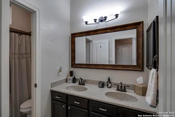 a bathroom with a toilet sink and mirror