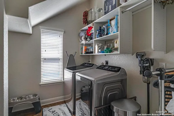 a utility room with dryer washer and a window