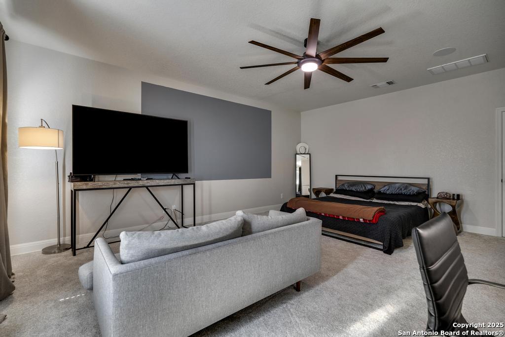 13326 Windmill Trace Helotes, TX 78023 - Photo 25 of 34 a living room with furniture and a flat screen tv