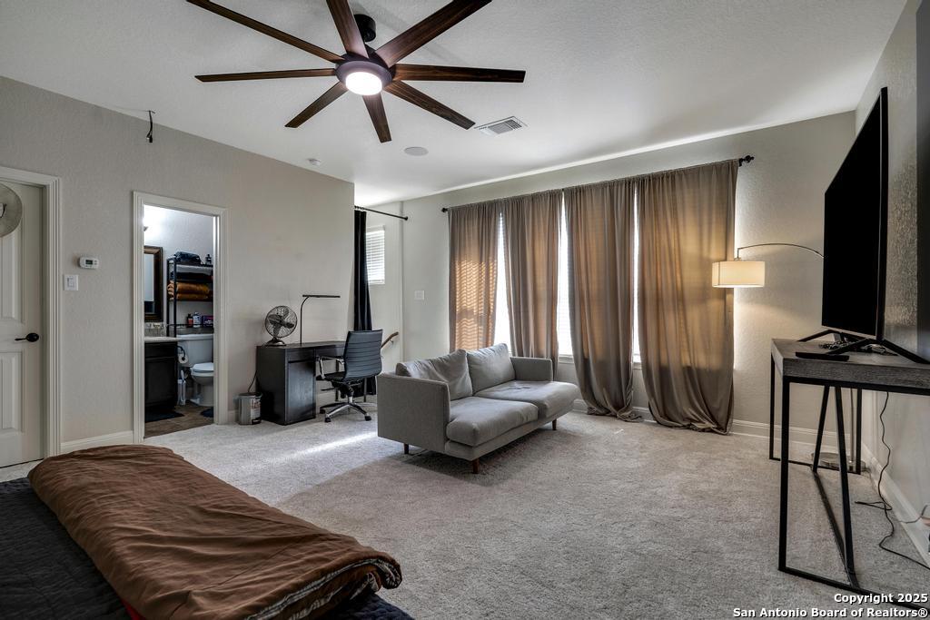 13326 Windmill Trace Helotes, TX 78023 - Photo 27 of 34 a bedroom with furniture and a flat screen tv