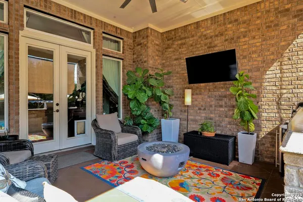 a living room with patio furniture and a flat screen tv