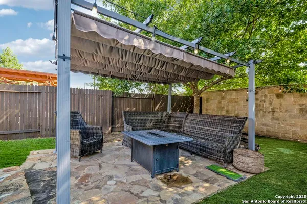 a view of a chairs and table in backyard of the house
