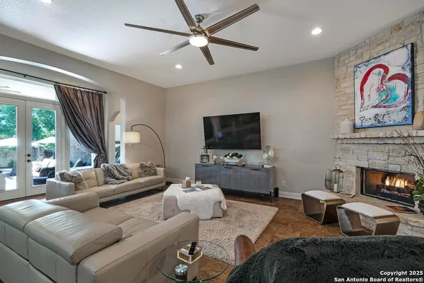 a living room with furniture a fireplace and a flat screen tv