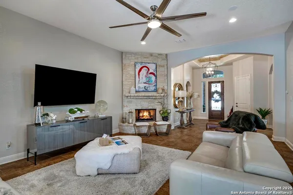 a living room with fireplace furniture and a flat screen tv
