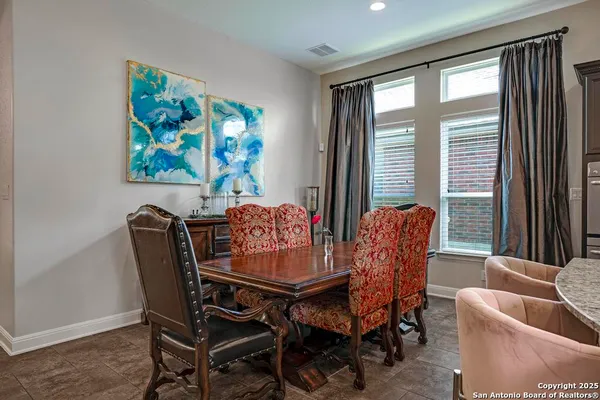 a dining room with furniture and window