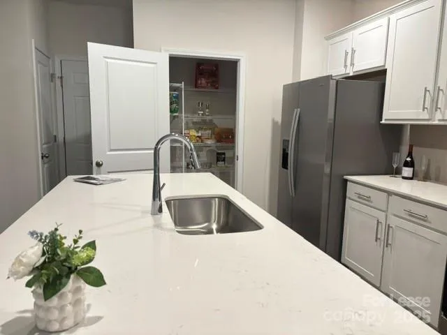 a kitchen with stainless steel appliances a sink a refrigerator and a sink