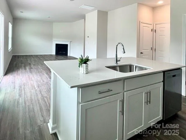 a kitchen with sink and mirror