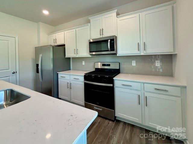 3667 Mercer Street Terrell, NC 28682 - Photo 18 of 38 a kitchen with stainless steel appliances white cabinets sink and a refrigerator