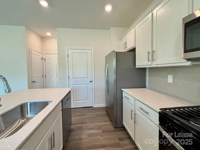 a kitchen that has a cabinets and a stove top oven