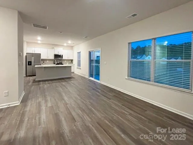 a view of kitchen with cabinets and wooden floor