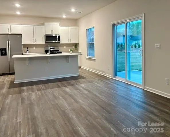 a kitchen with stainless steel appliances a refrigerator and a stove top oven
