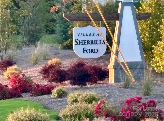 a sign that is sitting in front of flowers