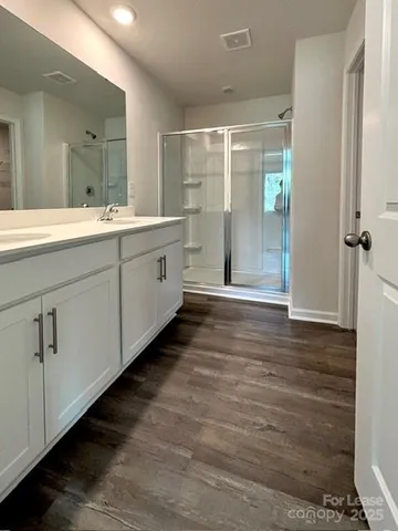 a bathroom with a double vanity sink and mirror