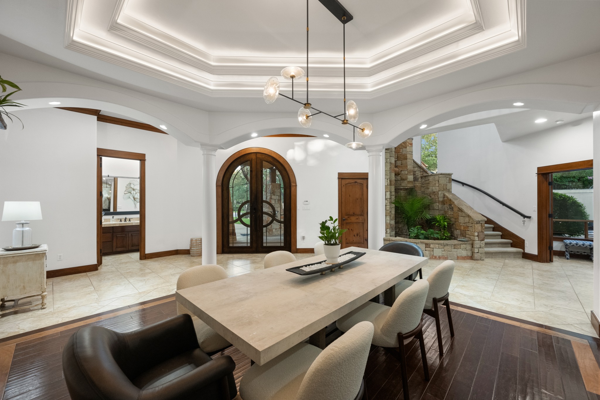 407 Hurst Creek Road Lakeway, TX 78734 - Photo 4 of 40 Upon entry from the custom steel double doors, you are instantly swept into stunning architecture. The formal dining makes a grand first impression.