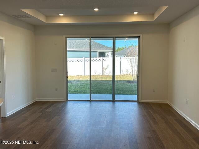 156 Camphor Laurel Road St. Augustine, FL 32092 - Photo 3 of 34 an empty room with wooden floor and windows