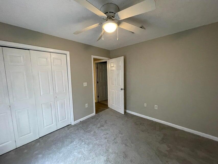 487 Woodlawn Road Freeport, FL 32439 - Photo 13 of 15 an empty room with closet and a chandelier fan