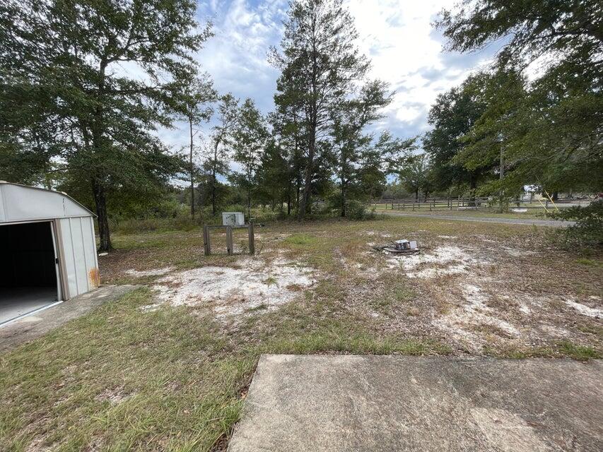 487 Woodlawn Road Freeport, FL 32439 - Photo 15 of 15 a backyard of a house with lots of green space
