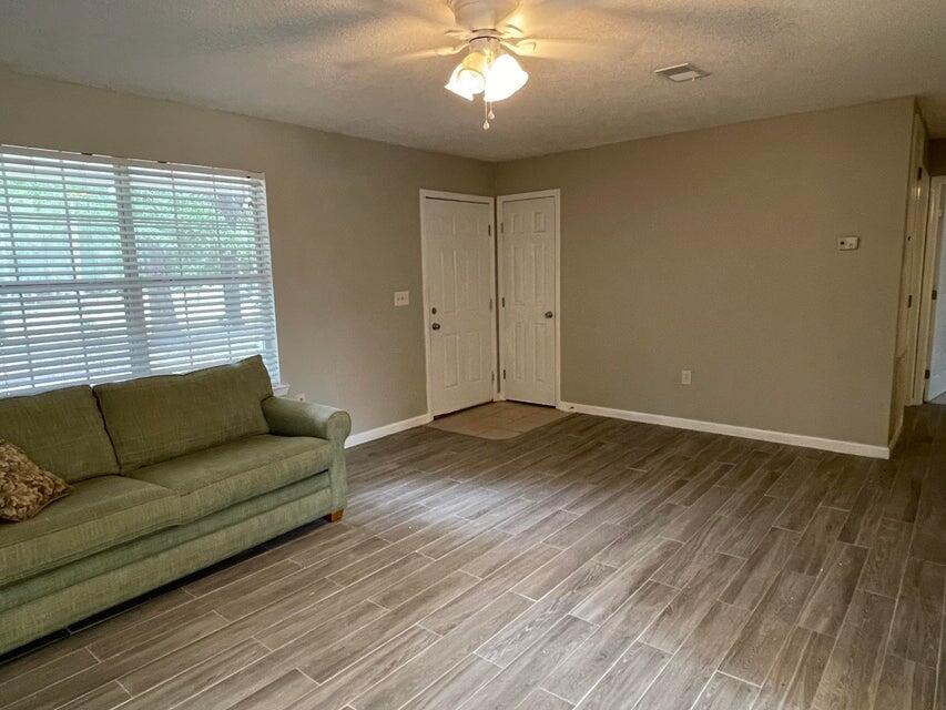 487 Woodlawn Road Freeport, FL 32439 - Photo 2 of 15 a living room with furniture and a large window