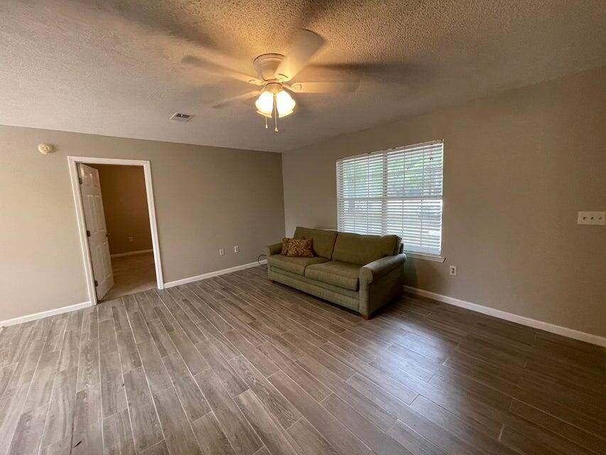 487 Woodlawn Road Freeport, FL 32439 - Photo 3 of 15 a living room with furniture and a wooden floor