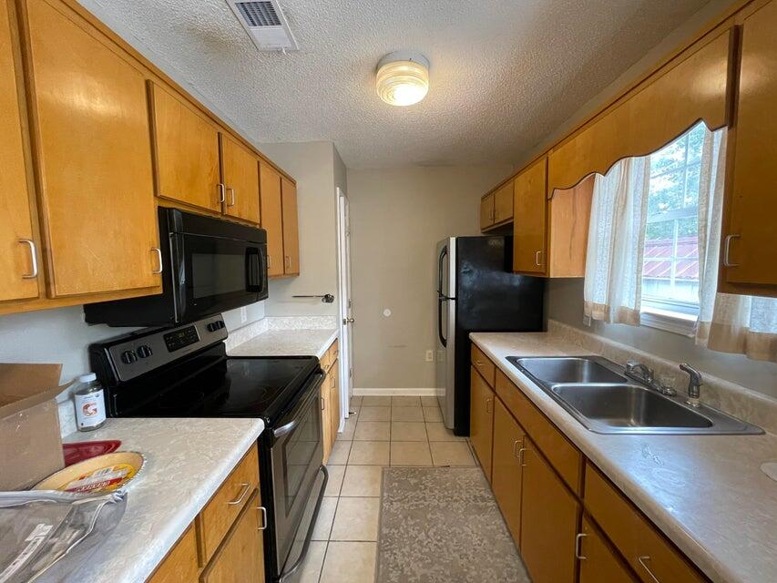 487 Woodlawn Road Freeport, FL 32439 - Photo 4 of 15 a kitchen with a sink stove top oven and refrigerator