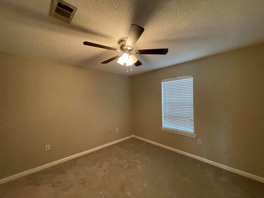 487 Woodlawn Road Freeport, FL 32439 - Photo 6 of 15 an empty room with windows and fan