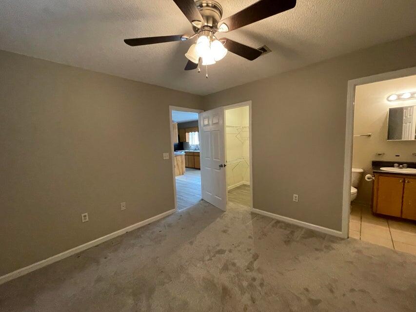 487 Woodlawn Road Freeport, FL 32439 - Photo 7 of 15 en empty room with closet and chandelier fan