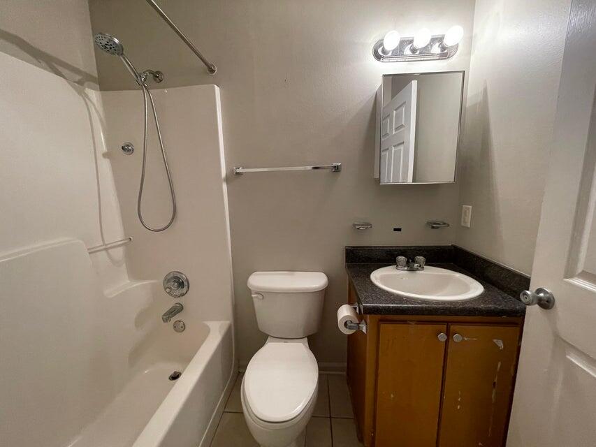 487 Woodlawn Road Freeport, FL 32439 - Photo 8 of 15 a bathroom with a toilet sink vanity shower and mirror