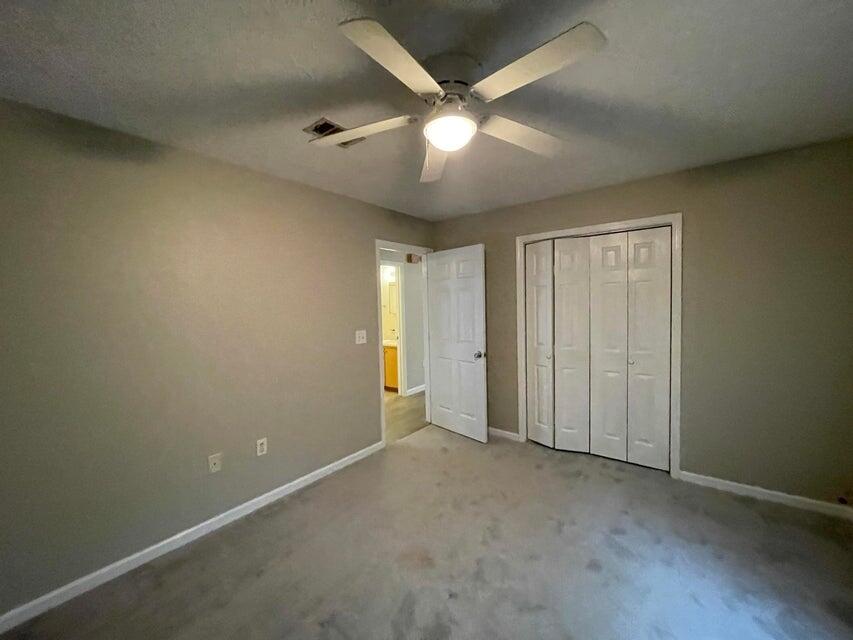 487 Woodlawn Road Freeport, FL 32439 - Photo 10 of 15 an empty room with a ceiling fan and a fan