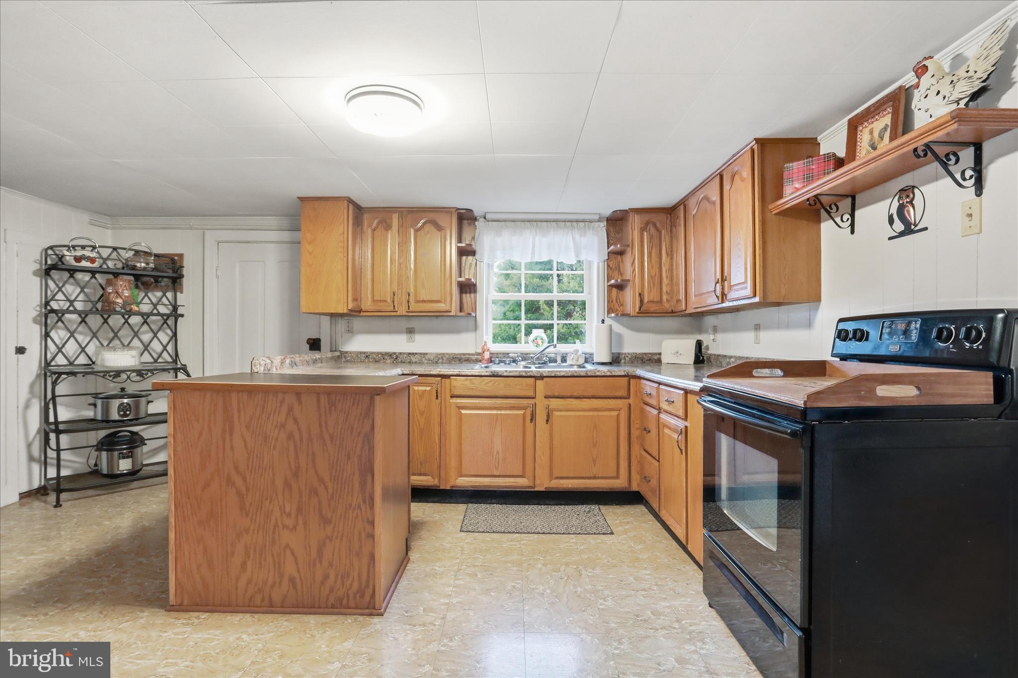 175 Clark Road Wardensville, WV 26851 - Photo 11 of 59 a kitchen with stainless steel appliances granite countertop a refrigerator stove and sink