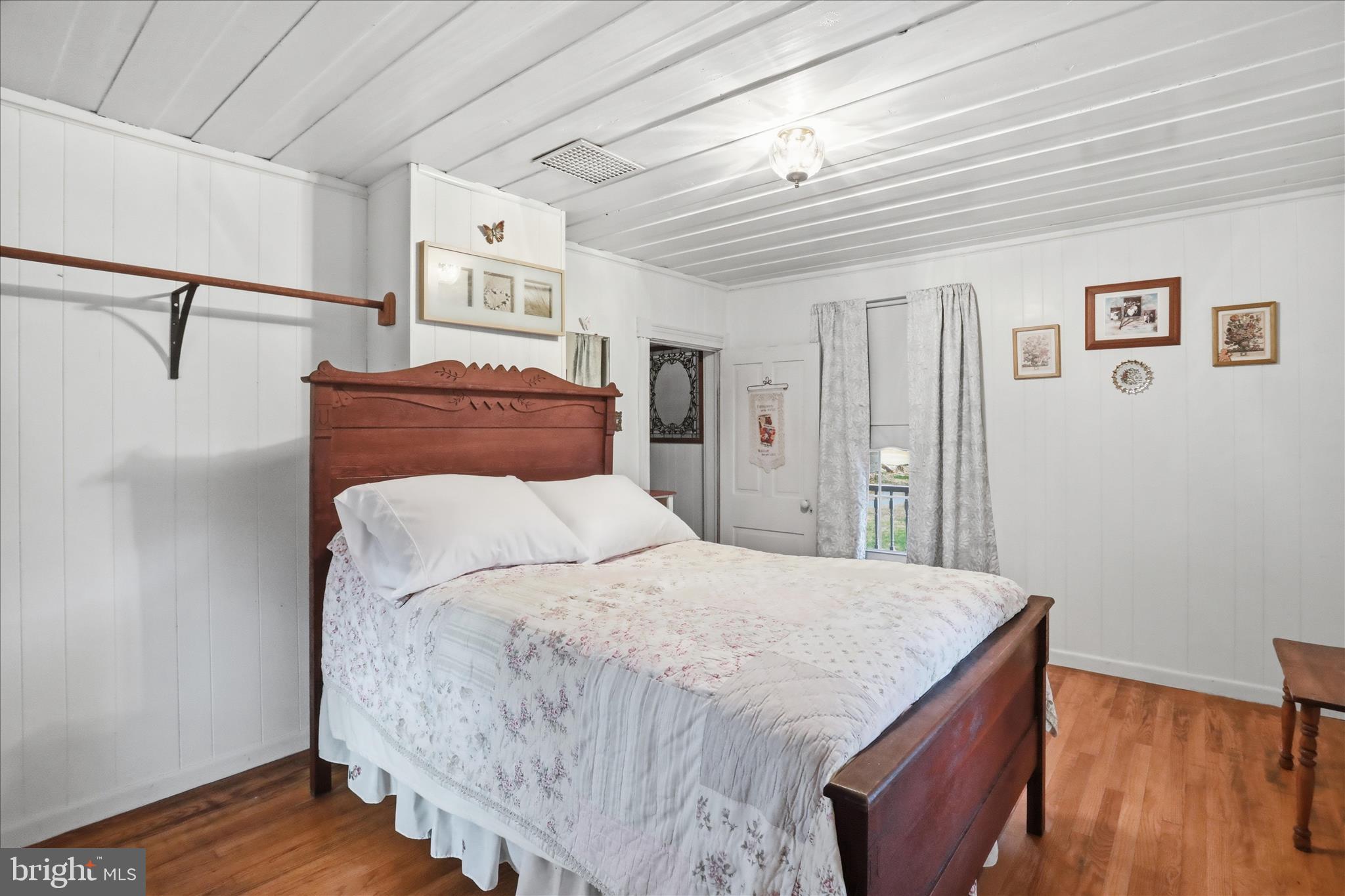 175 Clark Road Wardensville, WV 26851 - Photo 21 of 59 a bed room with a bed and a night stand