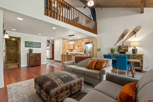 a living room with furniture or kitchen view and a wooden floor