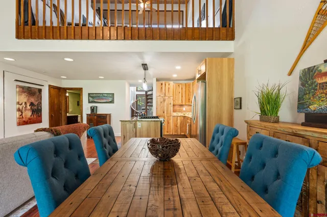 a living room with furniture a wooden floor and next to a window