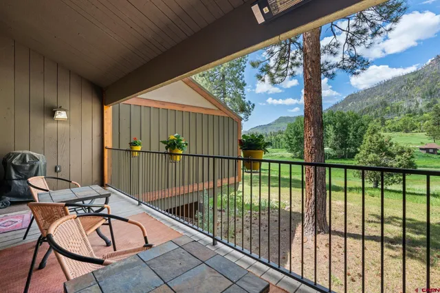 a view of a porch with a chairs in a yard