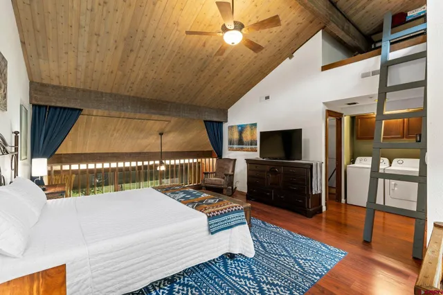 a bedroom with furniture and a flat screen tv